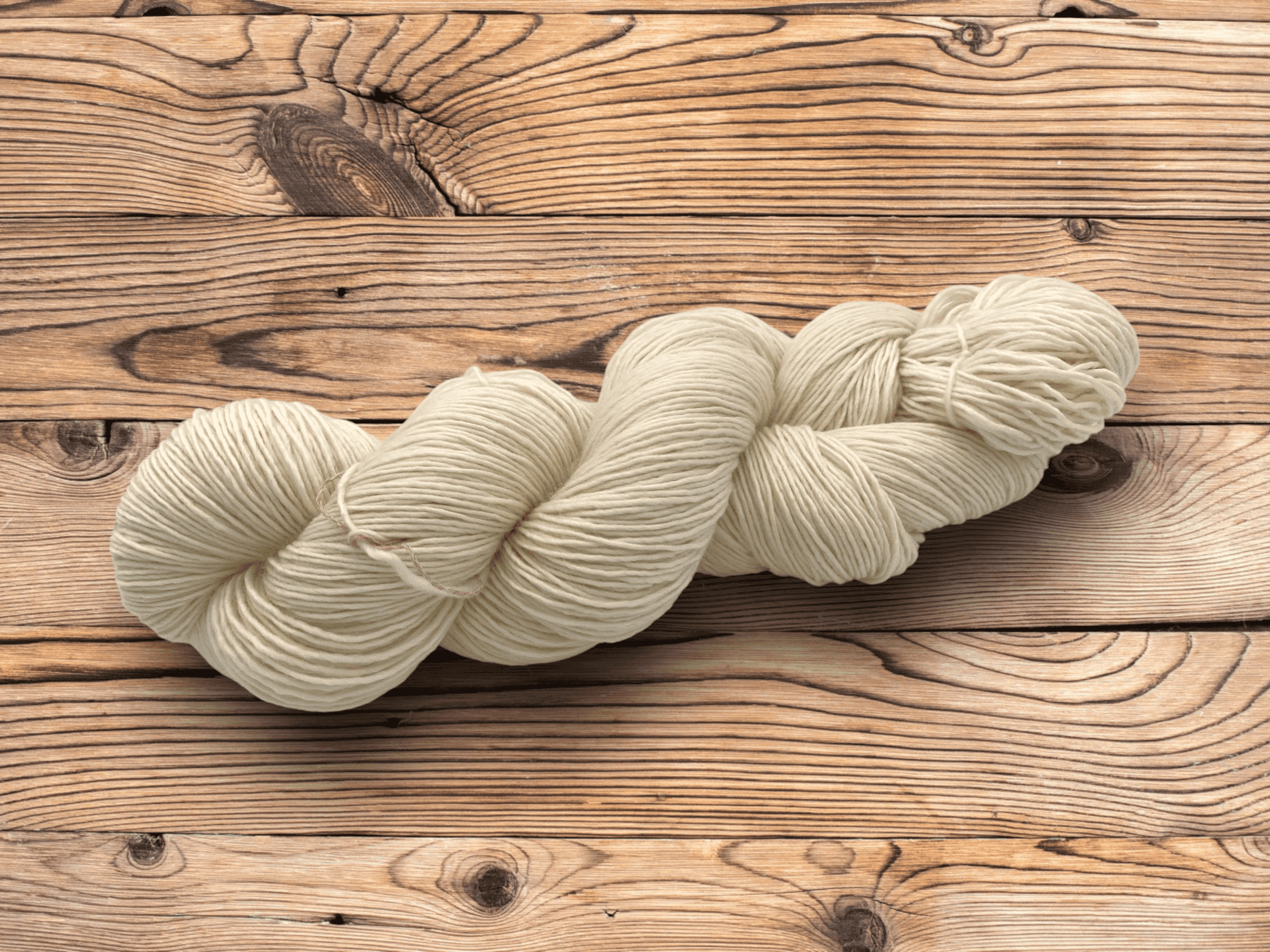 49194 Superwash Merino Single A photo of a skein of undyed merino yarn